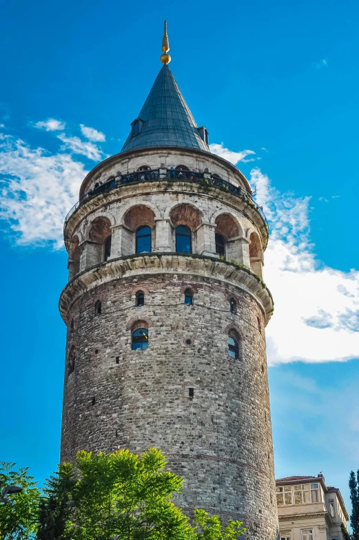 a tower with a blue top is pictured against the sky