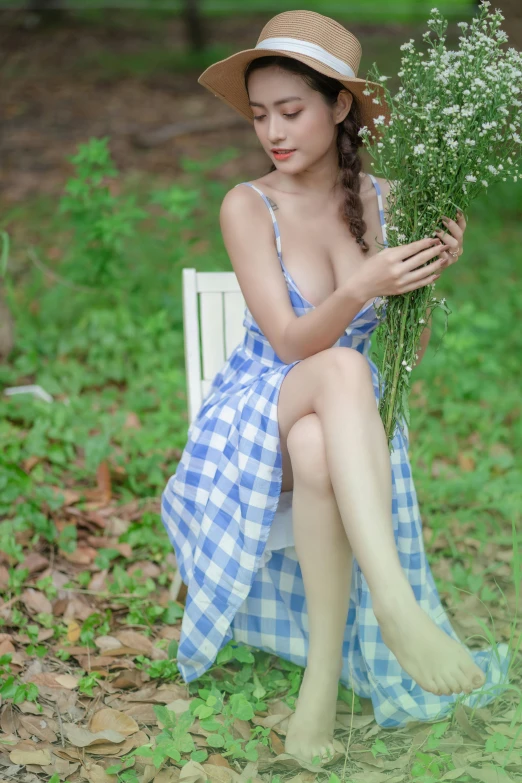 an asian woman with short hair sitting in a chair