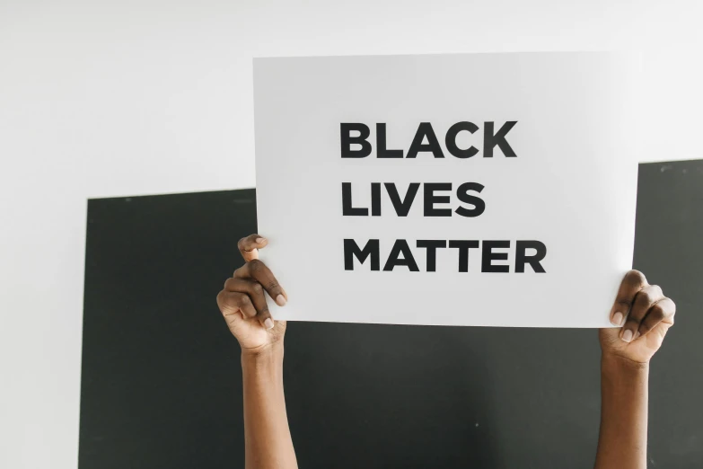 black lives matter paper held up by hands