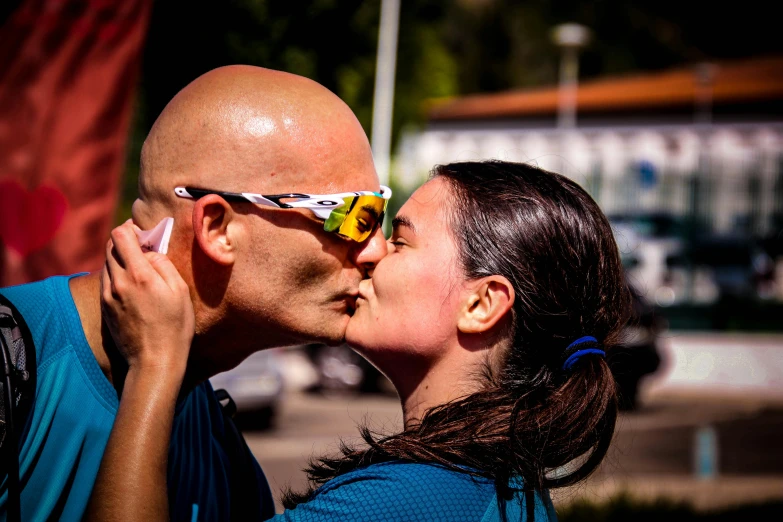 the young man and woman are kissing each other