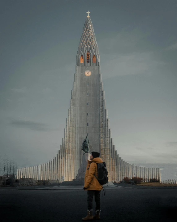 people are standing outside an unusual building at night