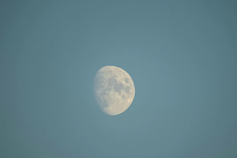 a big white moon in the middle of the sky