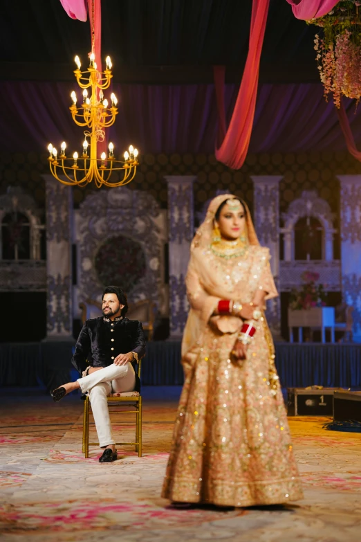 a man standing next to a woman dressed in indian garb