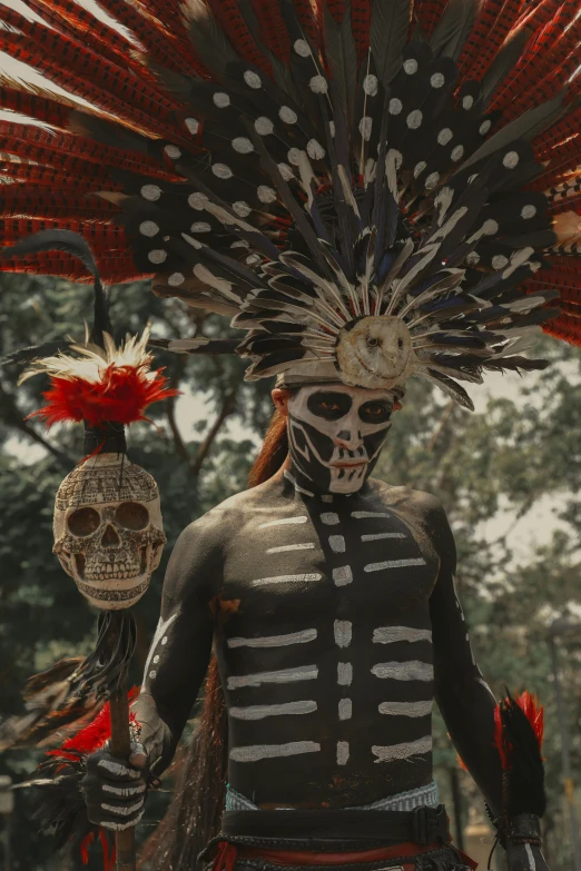 a skeleton mask man with feathers and feathers on his head