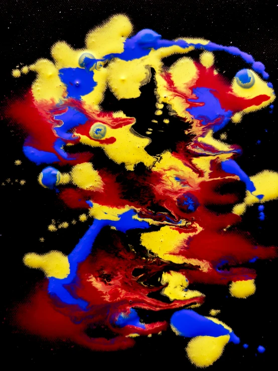 multi colored paint splashes on black background