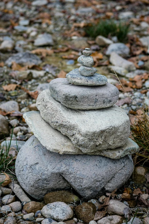 a pile of rocks sitting on top of a gravel field