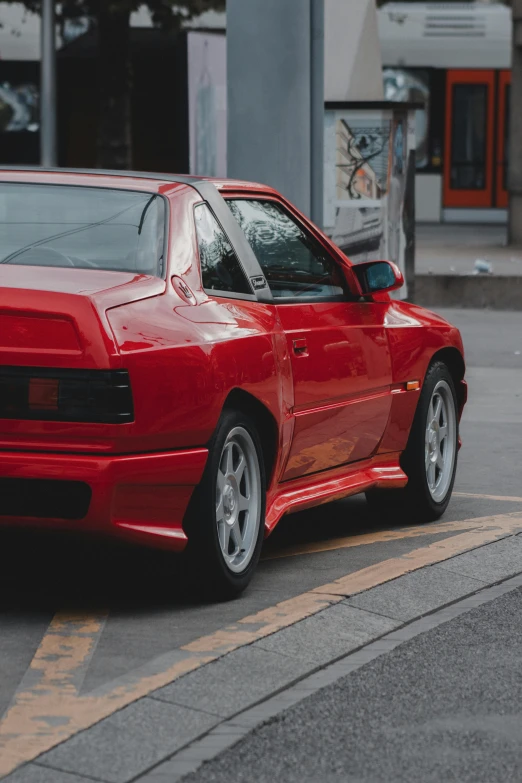 red sports car sitting at the side of the road