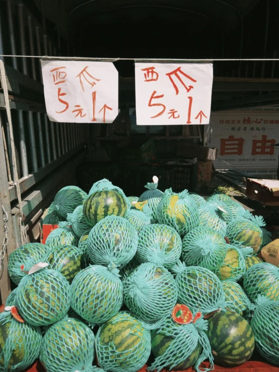 many baskets of watermelons that have been piled in different directions