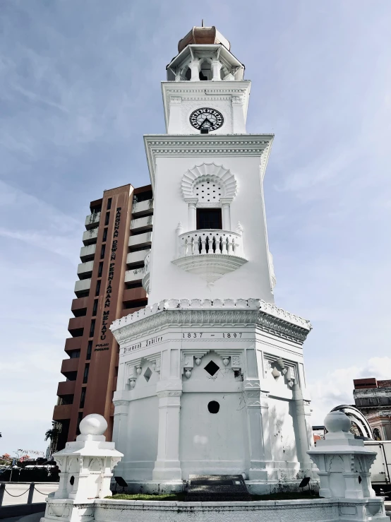 the tall clock tower has a circular roof on top