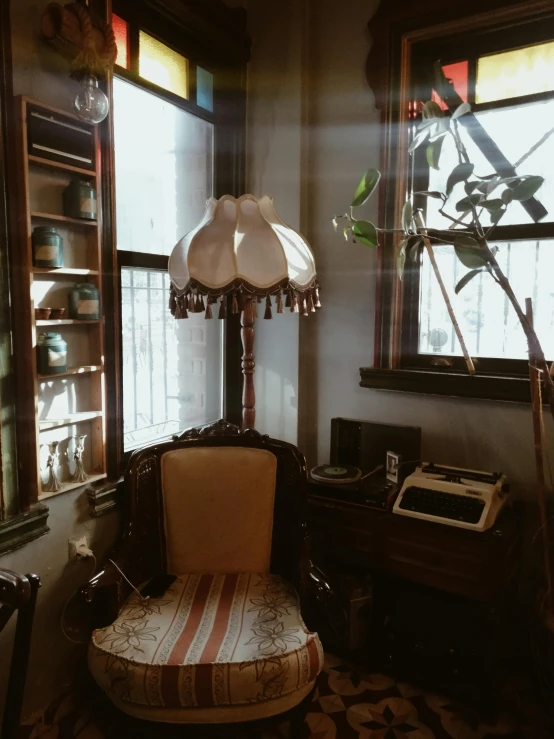 a white chair sitting in a corner of a room under a window