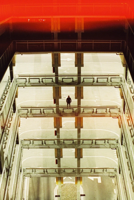 a man is seen from behind under a red light