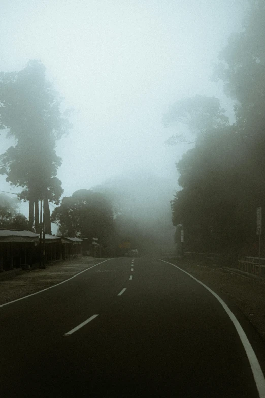 a street with some cars parked next to it on a cloudy day