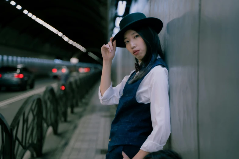 a person leaning against a wall while holding onto the handlebar