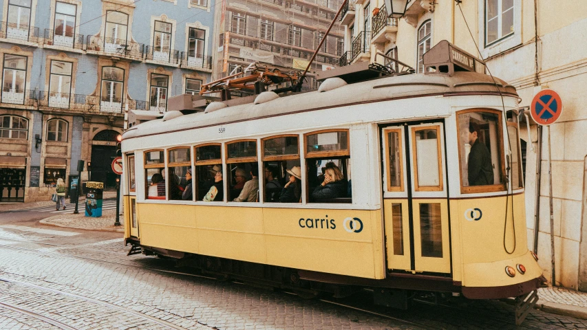 a large yellow tram that has people inside