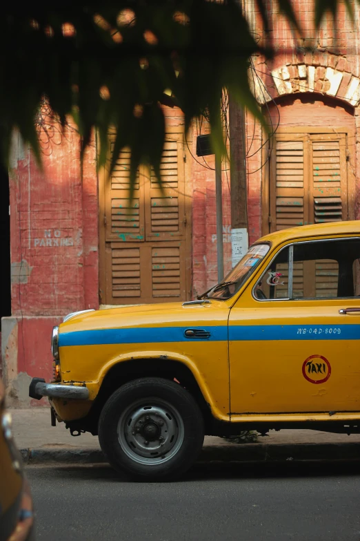 a yellow car that is parked in the street