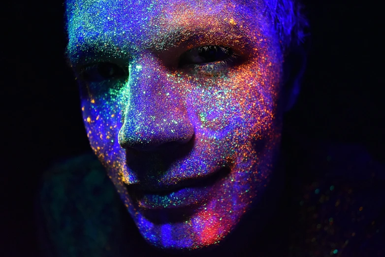 a man is shown in fluorescent colored powder