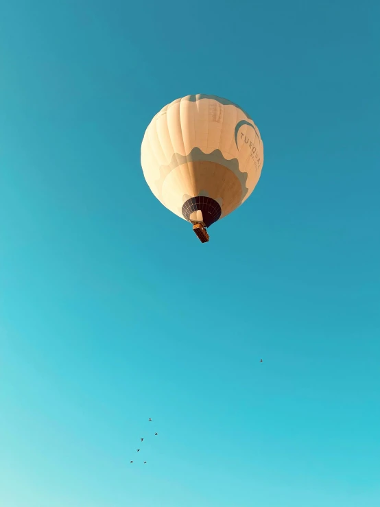 two  air balloons are flying over the beach