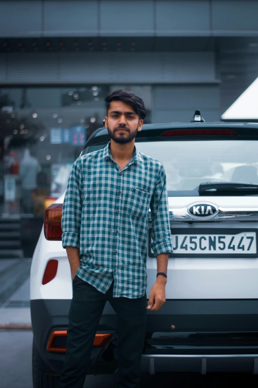 man standing next to parked car in urban area