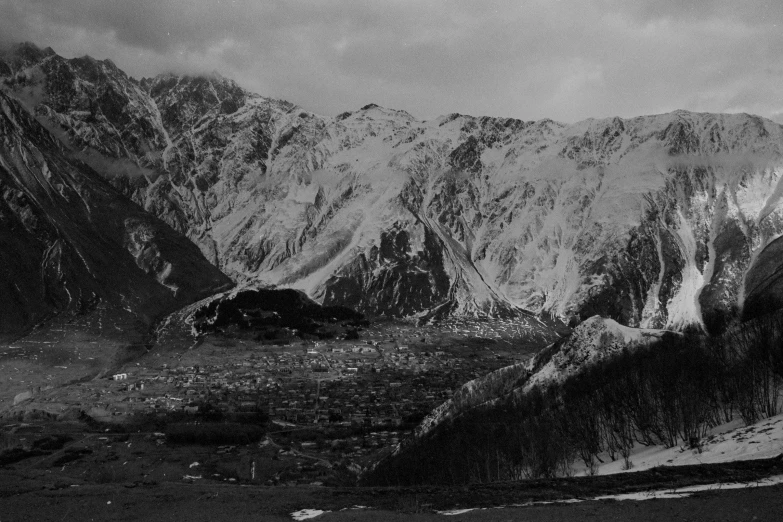 a black and white po of mountains covered in snow