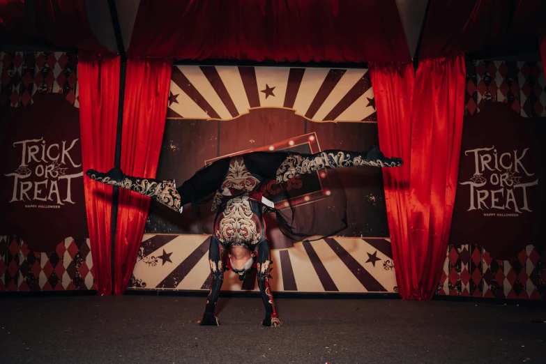 a circus performer on a horse with one leg in the air