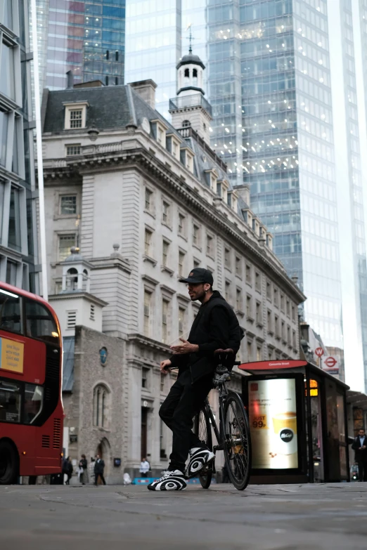 a man standing with a bike in the middle of the street