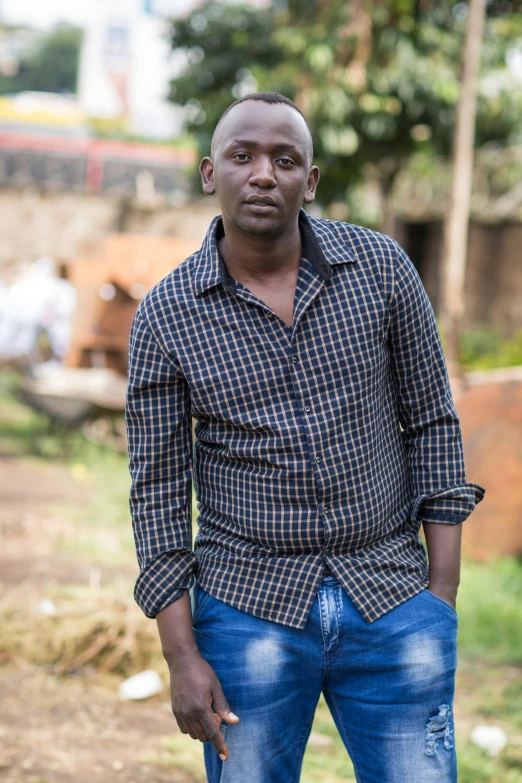 a man in blue pants is standing outside