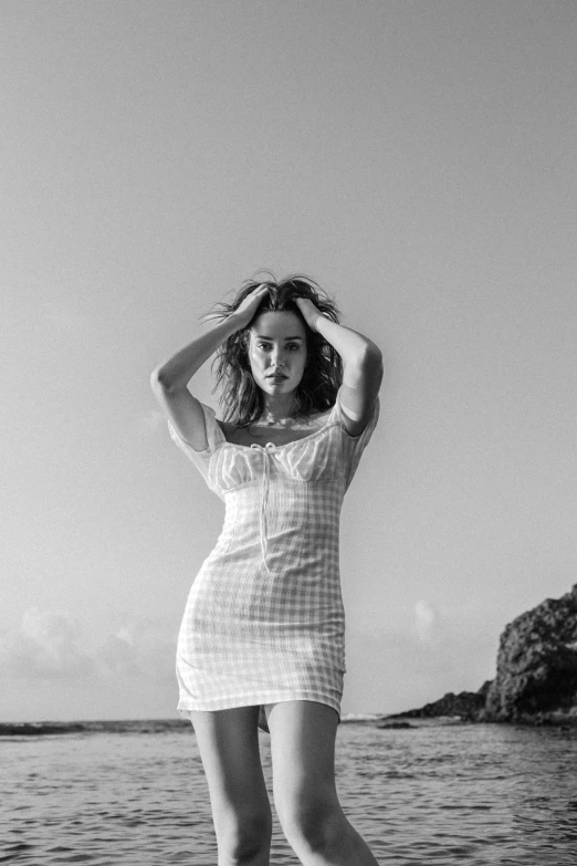 a girl is standing on a ledge in the water