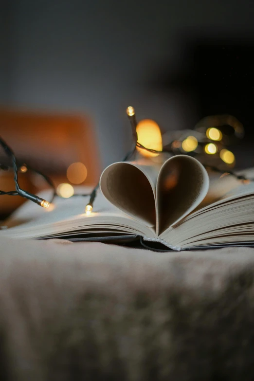 heart shaped book sitting on top of a table