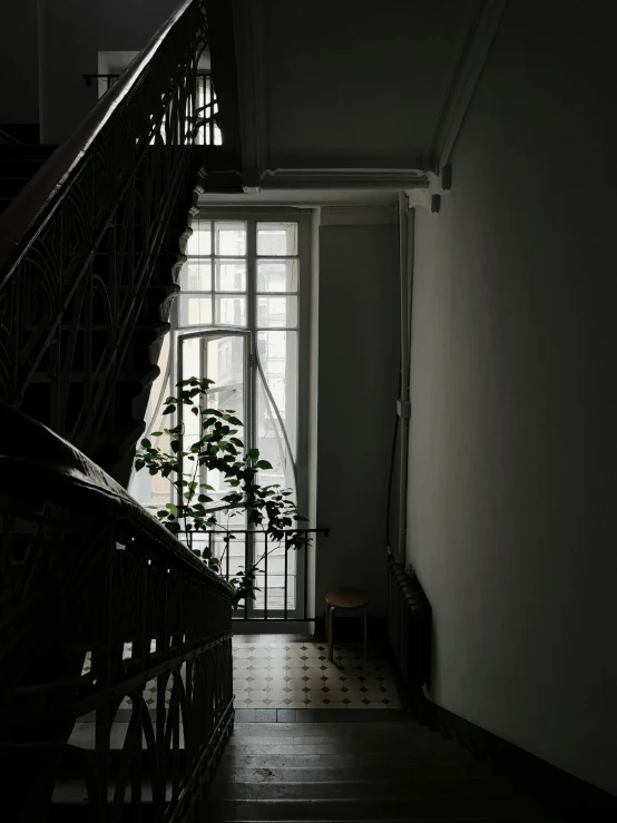 a staircase with an open window in the corner