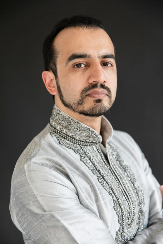 a man standing with his arms crossed in front of him