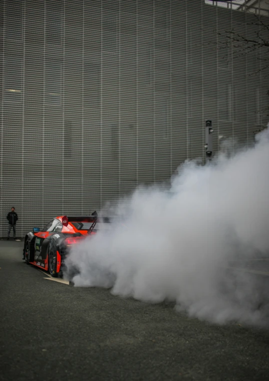 the car in the smoke is parked on a side walk