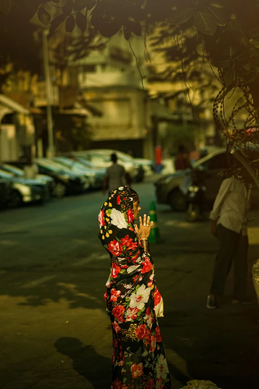 this woman is wearing a kimono walking down the street