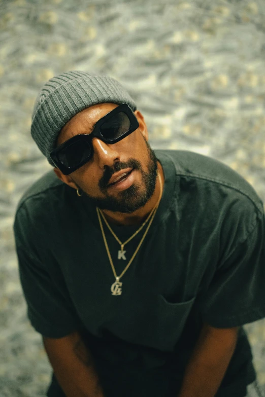 a man is wearing a beanie and some sunglasses