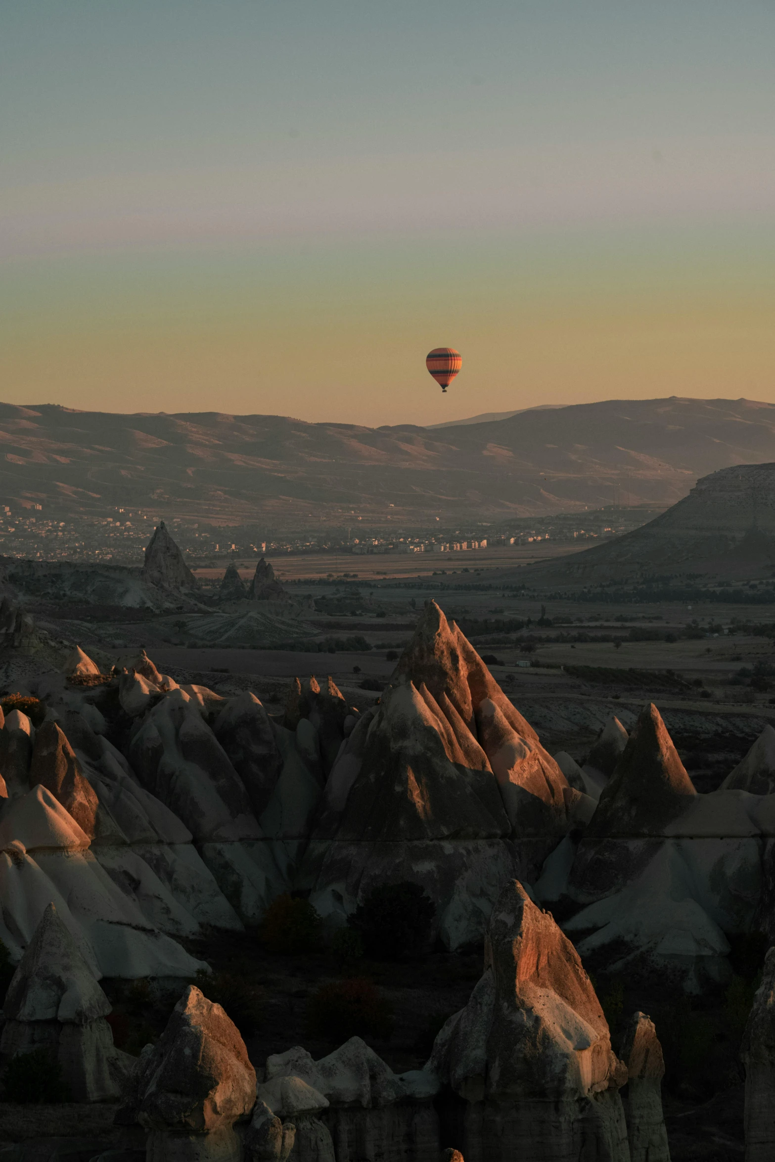 a balloon is flying over a mountainous area