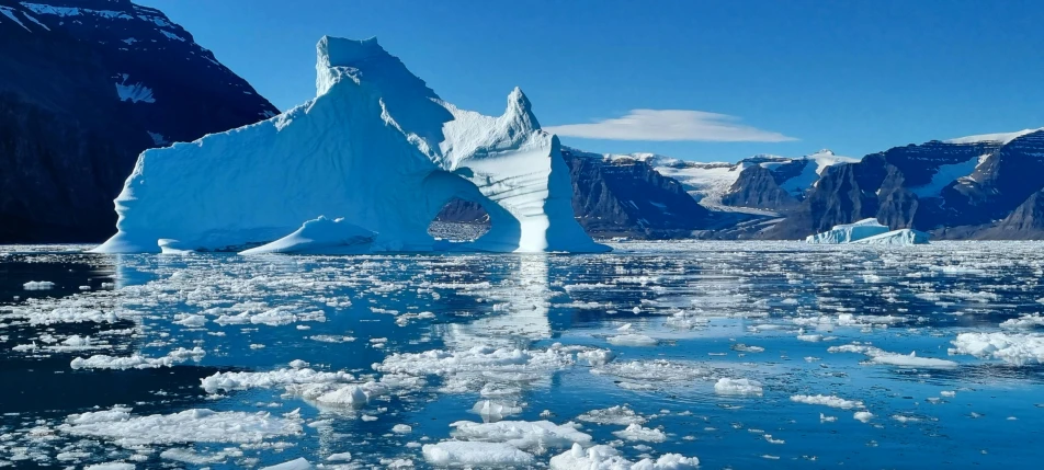 a big iceberg floating on top of the ocean
