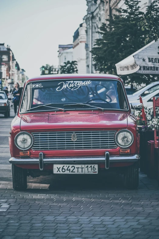 a red car parked on the side of a road