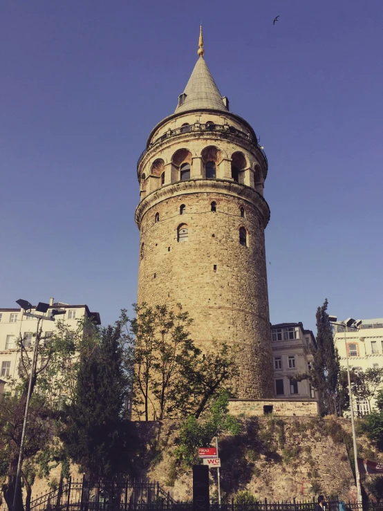 a tall stone tower with a clock on the top