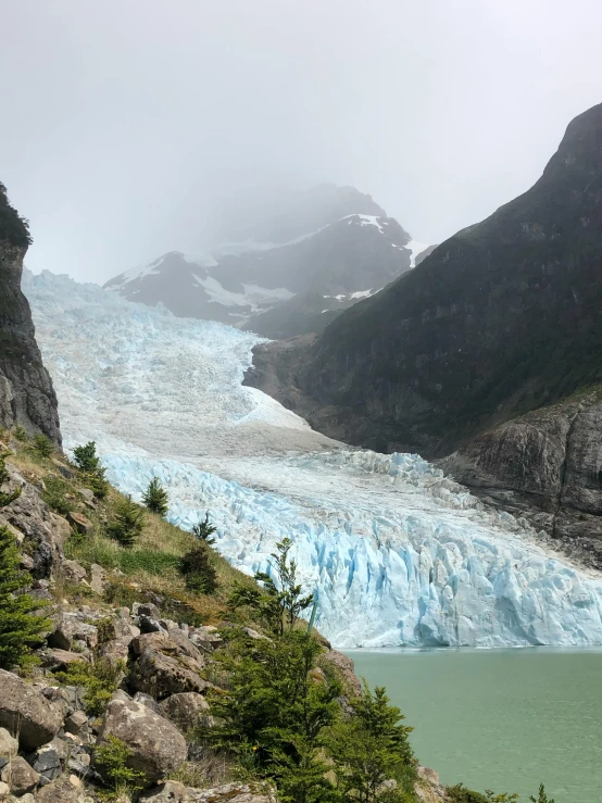 the water is blue and white on the mountain side