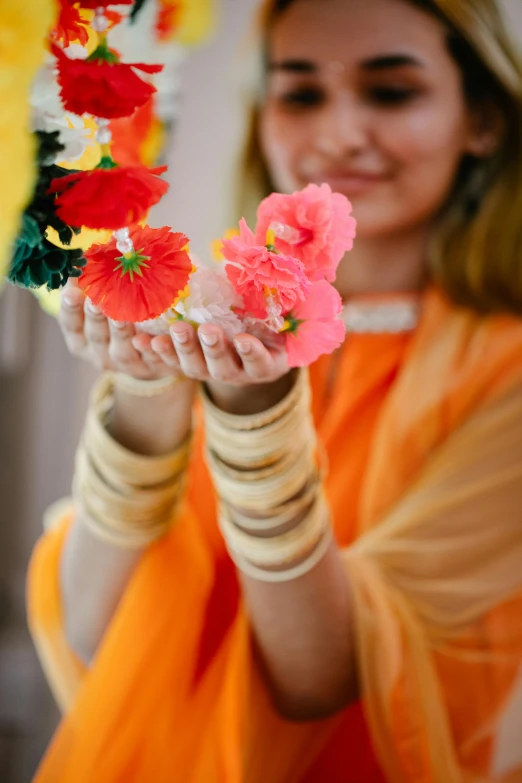 there is a girl holding flowers in her hands
