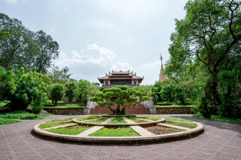 a park area with brick pavers and a fountain