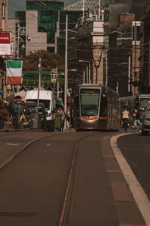 a bus stops on a city street near a busy road