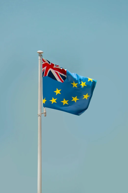 a flag on a flagpole with the australian and european flag flying side by side