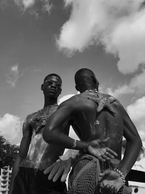 two men standing next to each other in the water