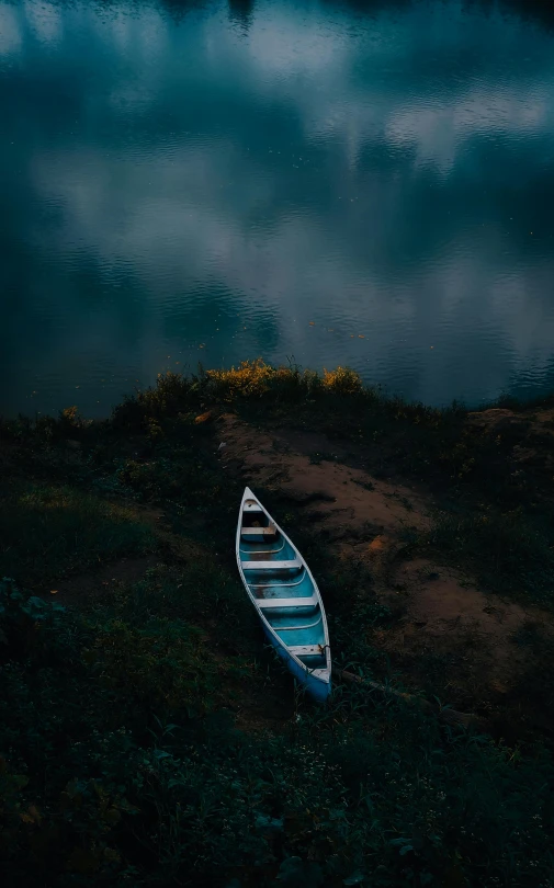 an empty boat is sitting on the grass