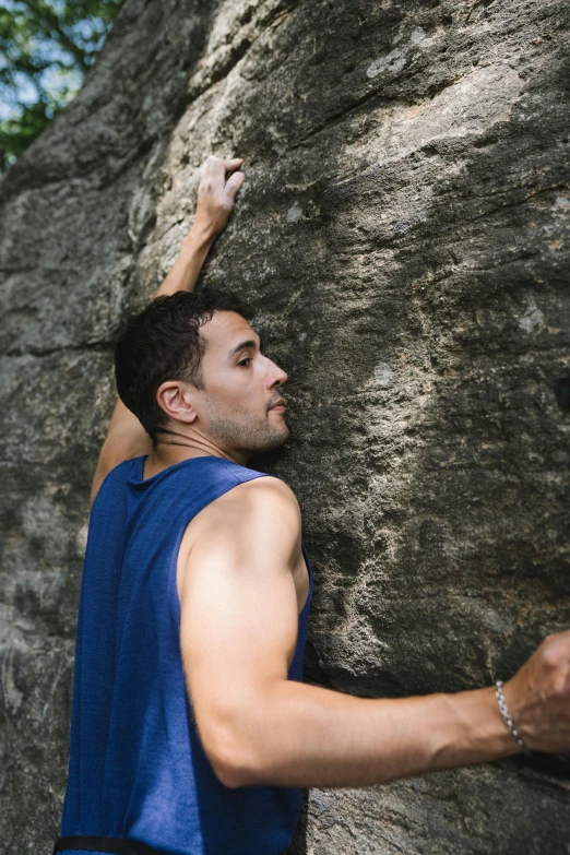 a man climbing up the side of a mountain