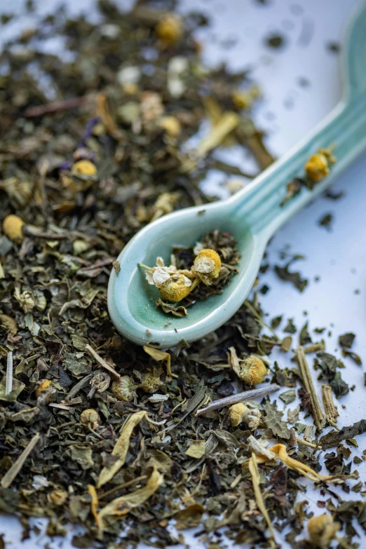 close up of a spoon full of various loose teas