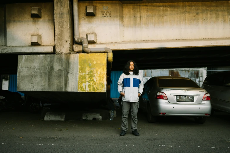 a person standing by some cars in a tunnel