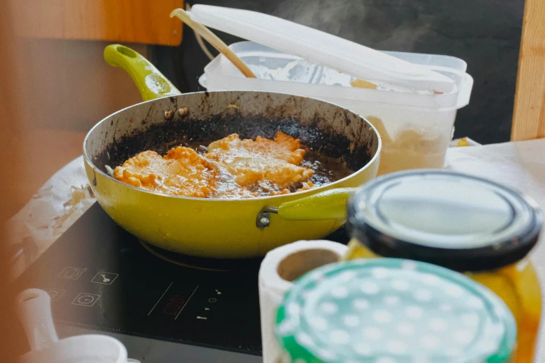 some food is in a yellow pot and on the table