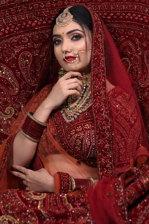 a woman sitting down wearing a red outfit