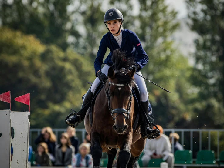 a person on a horse going around an obstacle